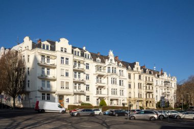 Wiesbaden, Germany - March 2, 2023: people at Kaiser Friedrich Ring - engl: King Friedrich circle - with its old scenic facade of the 19th century in classicistic and Art Nouveau style.