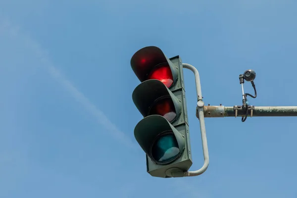 detail of red traffic light in Germany with camera