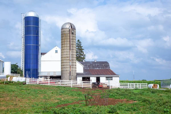 farm house with field and silo in beautiful landscape