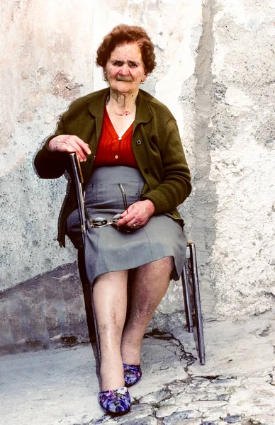 ポジターノの老婦人が彼女の家の前に座っているし 写真のポーズを楽しんでいますポジターノ イタリア 1995 — ストック写真