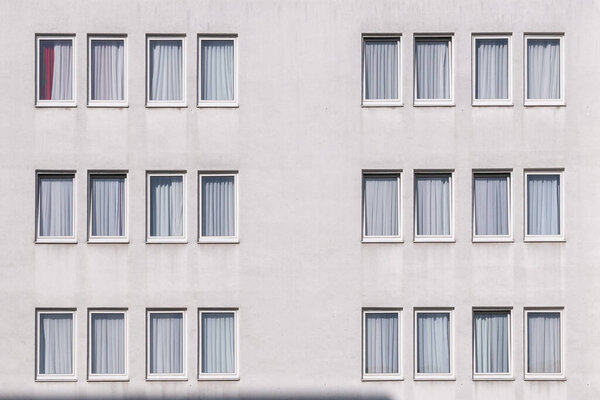 Pattern of a white house wall with windows in geometrical order as symbol and background