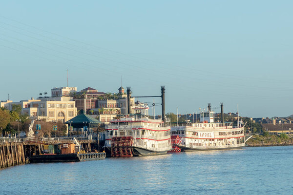 New Orleans, USA - October 27, 2023: morning view to Mississippi paddle steamer Natchez and City of New Orleans at the pier in New Orleans.