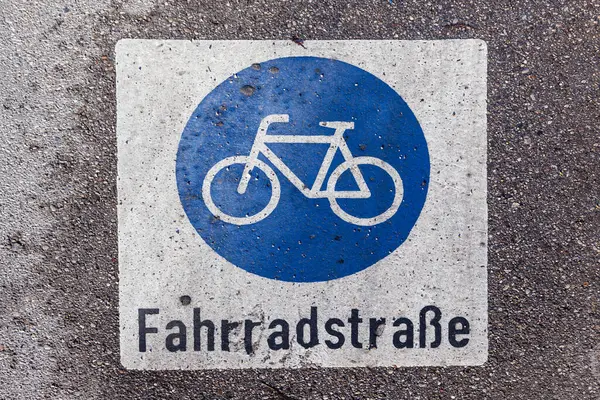 stock image sign bicycle lane painted at the wet street