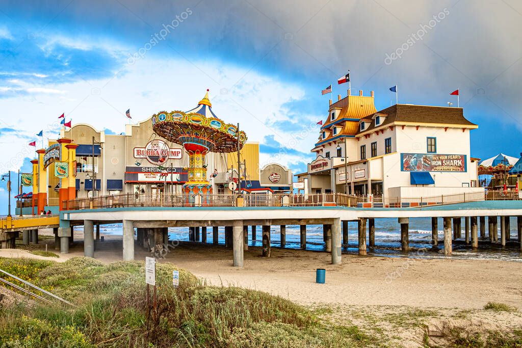 Galveston, USA - October 29, 2023: Pleasure Pier seen from the water in Galveston Island by bad weather conditions., Texas, USA.