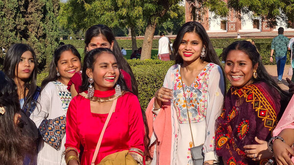Delhi, India - March 1, 2024: indian attractive female tourists  have joy posing for tourists at the red fort in New Delhi, India.