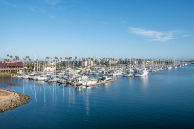 Ventura, USA - April 24, 2019: scenic view to harbor and sailing boats at pier at artifical channal of Ventura, USA. clipart