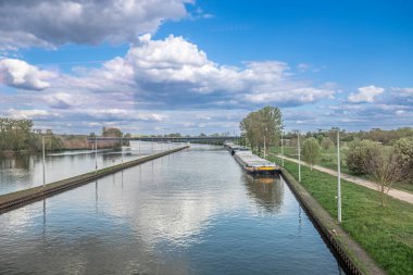 Mainz Kostheim 'de eski demiryolu köprüsünden Shio' nun rıhtımda beklediğini ve ana nehirdeki bulutların yansımasını gördüğünü söyledi.