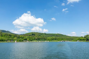 Schieder-Schwalenberg, Almanya - 11 Mayıs 2024: insanlar oyun parkı, pedal botları ve yiyecek ile Almanya 'daki Emmer Rezervuarı' nda eğleniyorlar.