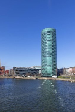 Frankfurt, Germany - February 28, 2023:  view to west harbor tower of Frankfurt at river Main, a modern skyline with lofts, apartments and expensive living area.. clipart