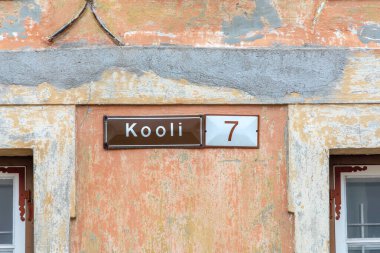 old enamel streetname Kooli 2  in Tallinn, Estonia at an old wall in the old town clipart