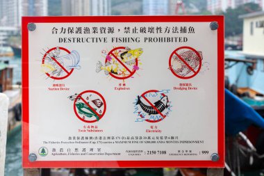 sign destructive fishing forbiden in mandarin and latin letters to warn people using explosives for fishing in Aberdeen, harbor at Hong Kong. clipart