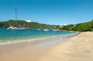 Princess Margaret beach near Port Elizabeth harbour in Bequia island, St Vincent and the Grenadines, Caribbean Sea region of Lesser Antilles. White sandy coral beach. clipart