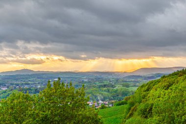 golden sunset at the  mountains of the saarland with dark rain clouds in sunset,Sarre,Germany clipart