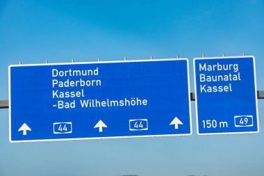 Karayolundaki mavi işaret Marburg, Kassel, Baunatal, Dortmund, Paderborn, Kassel 'i işaret ediyor.