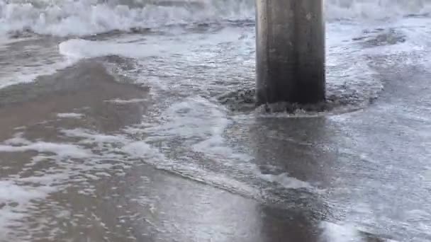 Water Gentle Wave Rolls Sandy Beach Giant Cement Pillar One — Stock Video