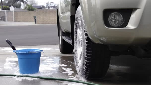Person Rinses Freshly Washed Soapy Tires While Cleaning Vehicle — Stock Video
