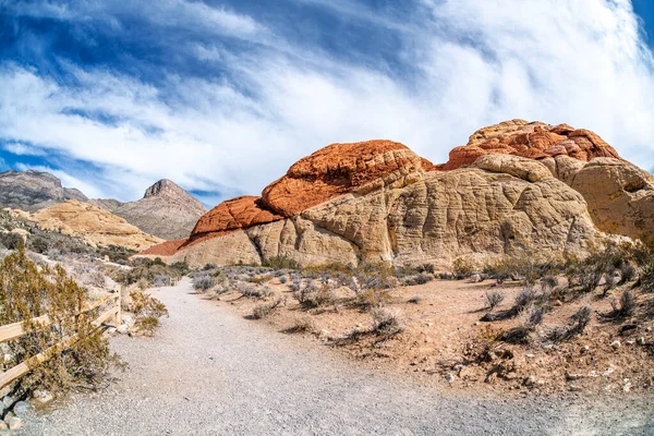 Hiking trail leading into the deep heart of Red Rock Canyon in Las Vegas shows a vibrant day to be active and enjoy leisure time.