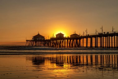 Huntington Beach pier at sunset  filtered by smoke from a nearby wildfire. clipart