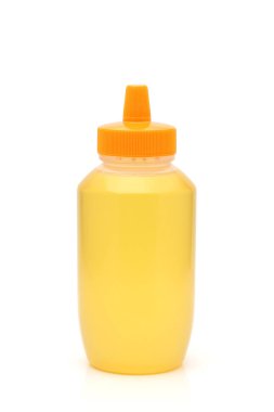 beyaz zemin üzerine bal plastik şişe