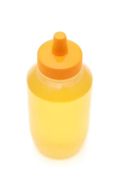 蜂蜜在白色背景上的塑料瓶 — 图库照片