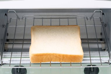 Tost makinesiyle bir dilim kızarmış ekmek pişirmeye yakın çekim. 