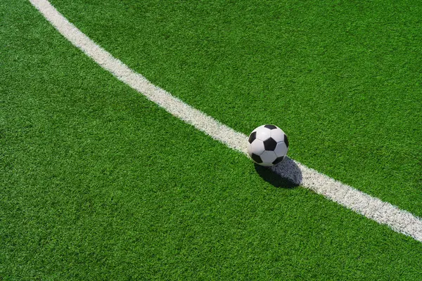 stock image a soccer ball on the green grass in soccer stadium.