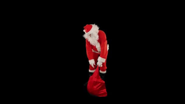 サンタクロースはプレゼントでいっぱいの袋で アルファチャンネルを作成するために彼の指をスナップ — ストック動画