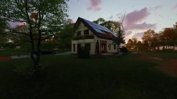 美しい夕日に対して湖の近くに太陽光パネルと風力タービンと緑の家 パニング4K — ストック動画