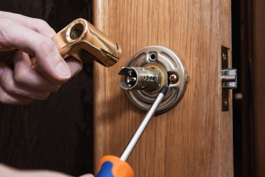 locksmith carpenter fix knob on wooden door by screwdriver for home service reparation