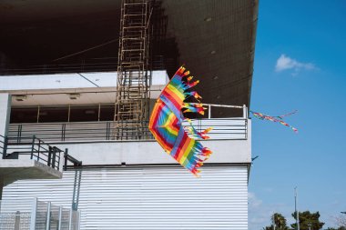 Colorful kite soars high in the sky Blue sky. Sports kite festival. Clean Monday in Greece. A flying kite with a wriggling tail. Copyspace