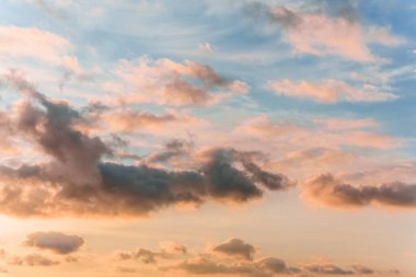 Fairy sunset sky with fluffy clouds. Sunset sky natural background. Dramatic Sky. Sunset In Yellow, Orange, Pink Colors. Feeling of dream or freedom. Copy space.