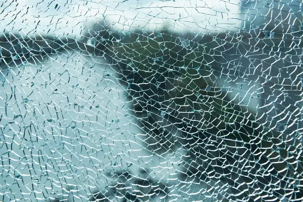 Stock image Shattered glass covered intricate cracks and patterns, texture background of broken or cracked glass