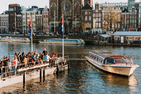 Stock image Tourists crowded at pier in Amsterdam's city center, waiting for canal tour boats - Netherlands, Amsterdam,12.11.2022