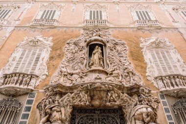 Valencia, İspanya 'daki Marques de Dos Aguas Sarayı' nın tarihi cephesinde çocuklu Bakire Meryem heykeli ve melekler.