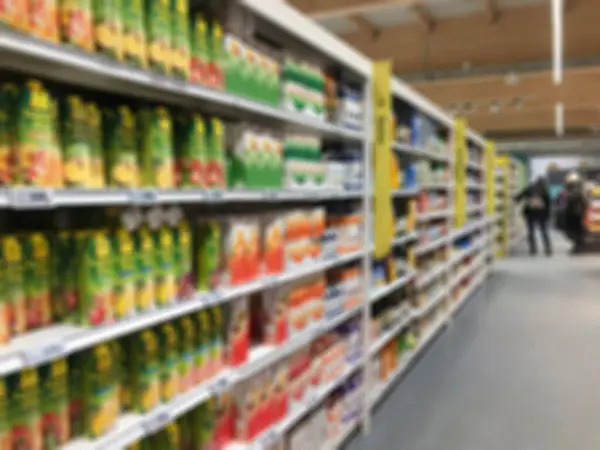 market, blurred background with variety of product packs on shelves in a supermarket aisle. blurry background of  supermarket interior with unreasonable customers or people shopping