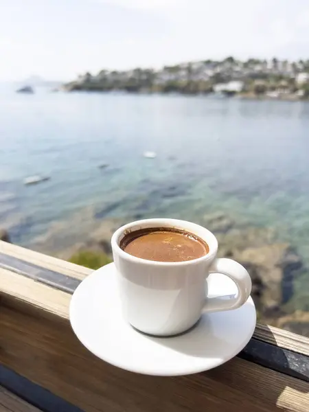 coffee, cup of Greek or Turkish coffee on table over beautiful calm sea and sky with copy space in a sunny summer day in Turkey. traditional turkish hot drink or beverage. espresso cup over sea view