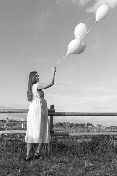 Woman Balloons Stands Fence Middle Field Looks Distance Monochrome Photo — Stock Photo, Image
