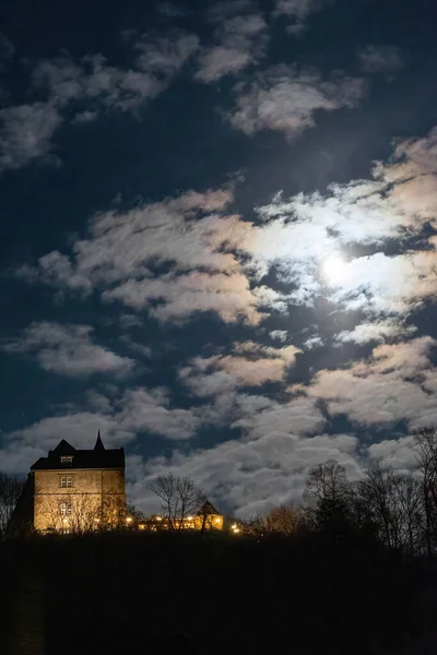 Moonlit night in an old German town, cloudy sky and full moon