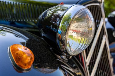 Schieder-Schwalenberg, North Rhine-Westphalia, Germany, May 8, 2022: Headlight of a retro car, close-up photo