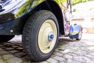 Rear wheel of a vintage black retro mobile close-up
