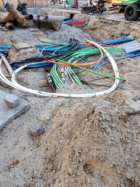 Earthworks during the replacement of the pavement in the city square. Laying of electrical cables.