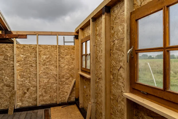 Construction of a garden wooden house, view from the inside, walls from oriented strand board