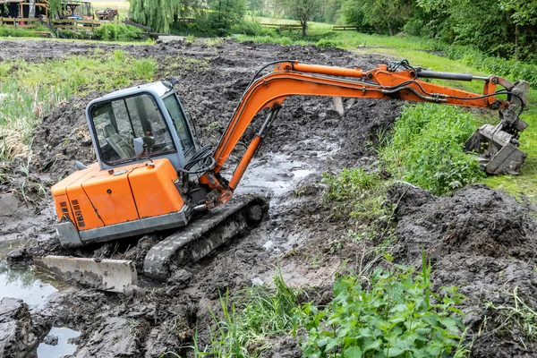 挖掘机清理布满芦苇的淤泥湖面 — 图库照片