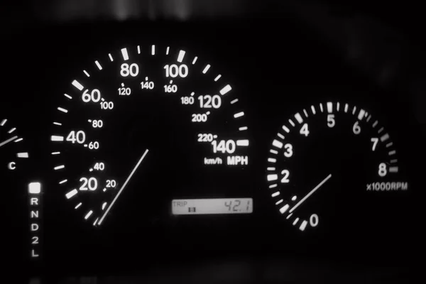 analog automotive devices. cars from the nineties. arrows on the dashboard. speedometer. tachometer. black and white.