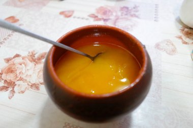 Bal kavanozu. bal ve demir kaşık. Bal karıştırıyorum. kahverengi kil çömlek.