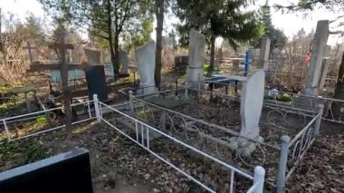 Ukrina. January 11, 2023. Old cemetery. Abandoned graves. Broken headstones. Fresh graves. footage in high quality. 4k video