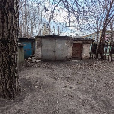 the city of Dnipro. Dnepropetrovsk region. Ukraine. January 11, 2023. old garages. parking for cars. retro gate. graffiti on the wall. graffiti on the walls. paint on the wall. Soviet houses.