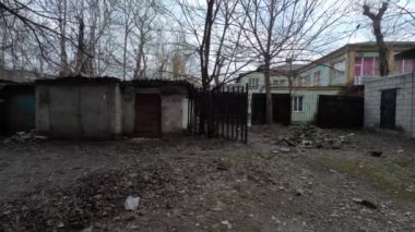 the city of Dnipro. Dnepropetrovsk region. Ukraine. January 11, 2023. old garages. parking for cars. retro gate. graffiti on the wall. graffiti on the walls. paint on the wall. Soviet houses.