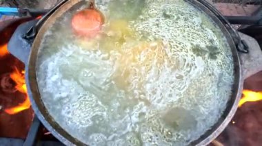 pot on fire. kettle on fire. Cooking on an Open Fire in a Tourist Pot. Cooking at the stake in a tourist bowler hat. Hiking. Tourist pot at bonfire. Large pot on a campfire on a camping trip