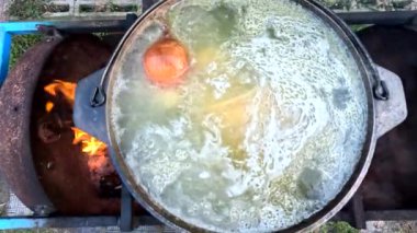 pot on fire. kettle on fire. Cooking on an Open Fire in a Tourist Pot. Cooking at the stake in a tourist bowler hat. Hiking. Tourist pot at bonfire. Large pot on a campfire on a camping trip